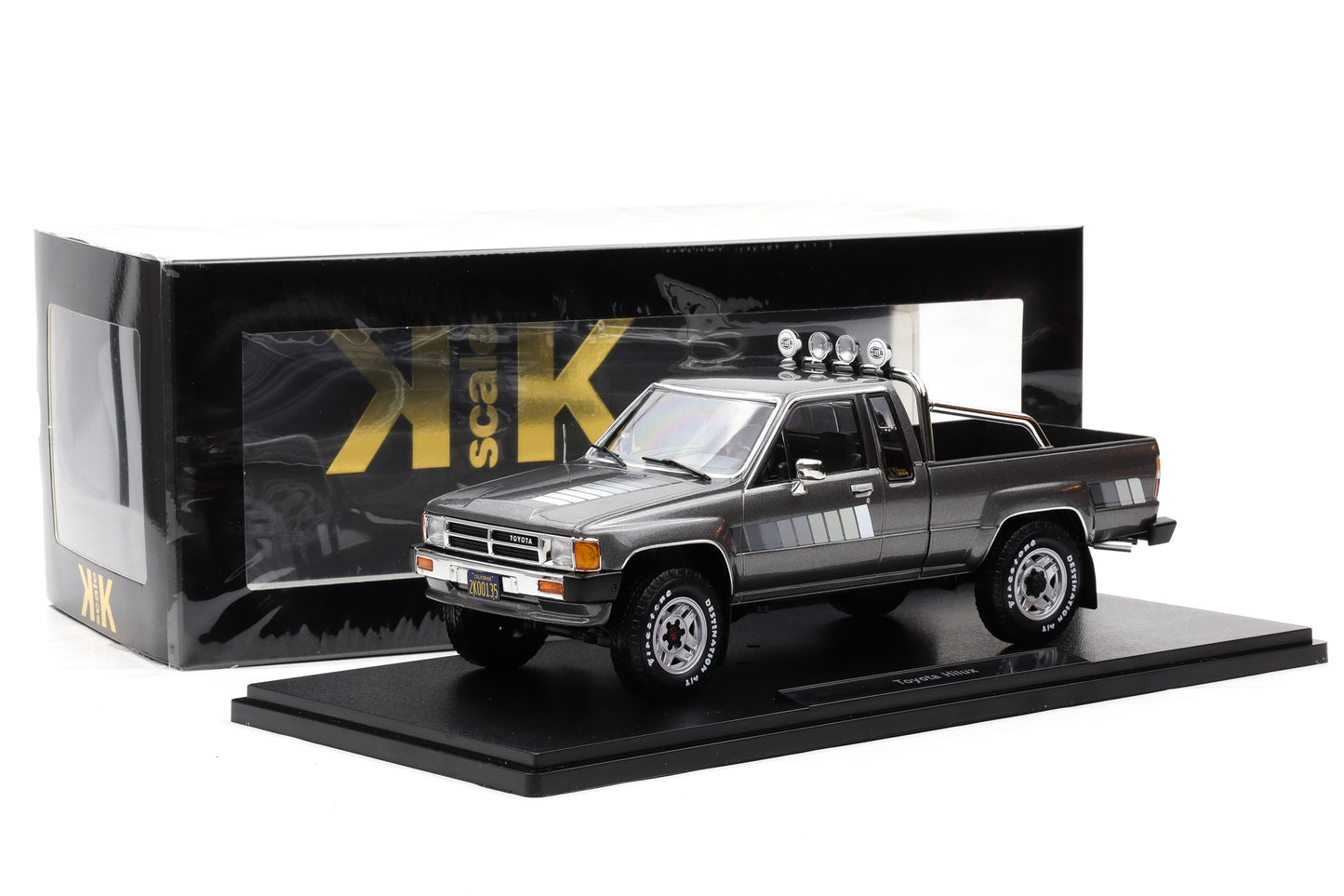 1:18 Toyota Hilux SR5 Truck Xtra Cab 4x4 1985 graumetallic Decor weiß KK Scale