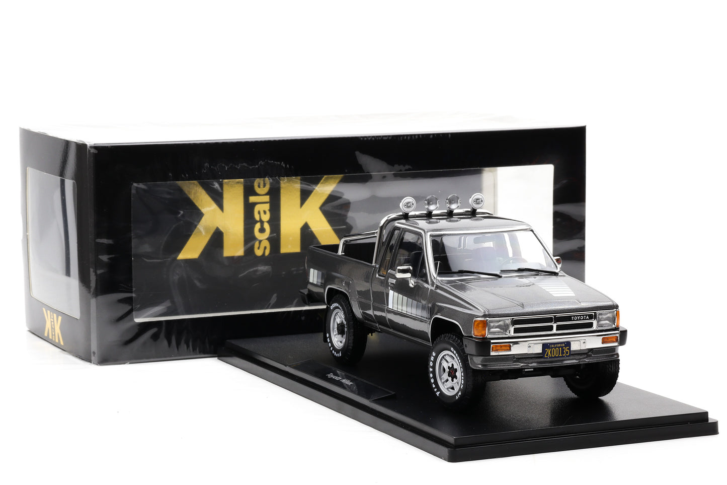 1:18 Toyota Hilux SR5 Truck Xtra Cab 4x4 1985 graumetallic Decor weiß KK Scale